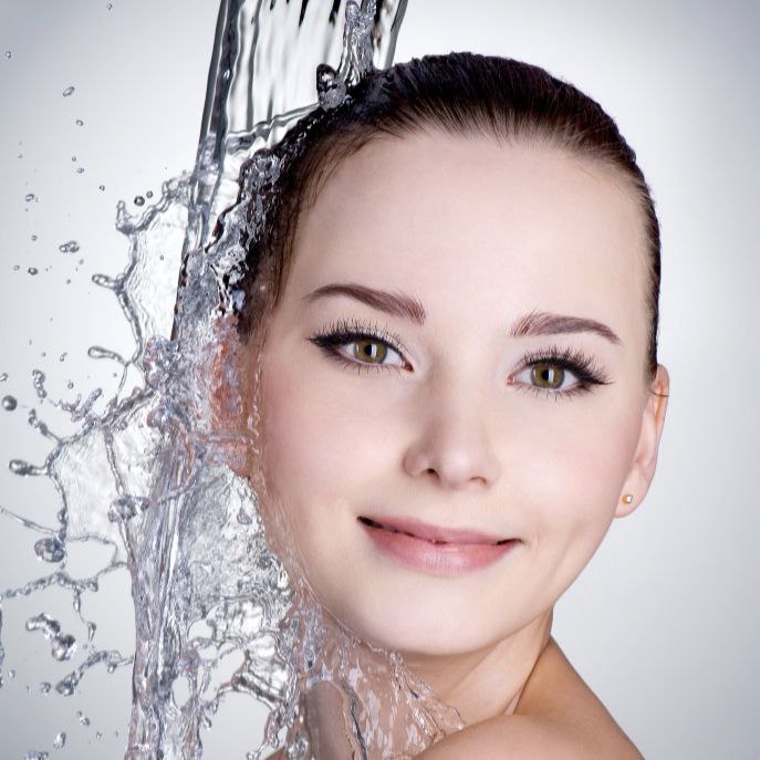 image of a girl and moisturizing her skin with water